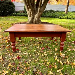 A Reclaimed Barn Wood Plank Coffee Table With Painted Turned Legs