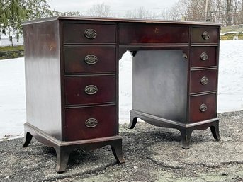 A Vintage Kneehole Desk With Glass Top