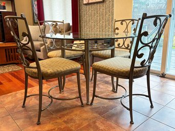 A Wrought Iron Glass Top Dining Table And Set Of 4 Chairs