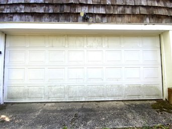 A Metal Clad  Garage Door With Track And Opener