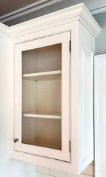 A Single Upper Cabinet With Bubble Glass Paneled Door