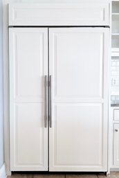 A Sub Zero 632 Side By Side Counter Depth Refrigerator With Wood Paneled Doors