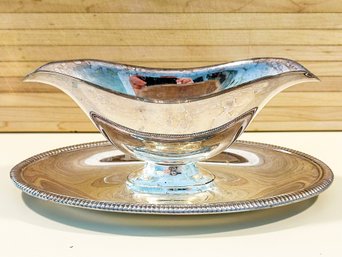 A VINTAGE SILVER PLATED GRAVY BOAT AND UNDERPLATE