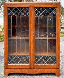 An Early 20th Century Quarter Sawn Oak Bookcase With Leaded Glass Doors