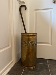 An Embossed Brass Umbrella Stand With A Cane