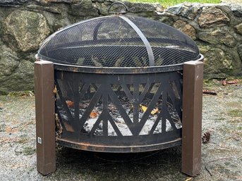 A Metal And Mesh Outdoor Fire Pit