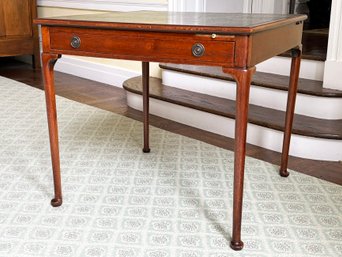 An Antique Leather Clad Desk With Pullout Writing Surface