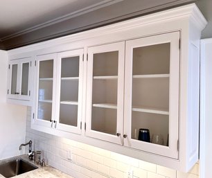 A Run Of Upper Cabinets With Bubble Glass Paneled Doors