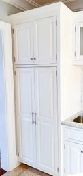 A Large Paneled Wood Pantry Cabinet With Pullout Drawers