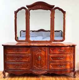 A Fruit Wood Dresser With Tri-Fold Mirror IN French Provincial By Bassett Furniture