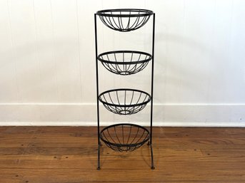 A Tiered Basket Stand In Black Metal