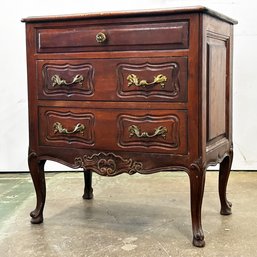 An Early 20th Century Paneled Oak French Provincial Nightstand