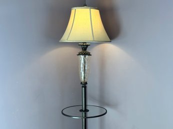 An Elegant Floor Lamp With A Glass Table Surface