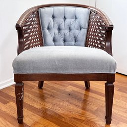 A Vintage Club Chair With Cane And Tufted Upholstery