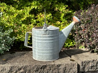 A Watering Can In Galvanized Metal With A Flat Bottom