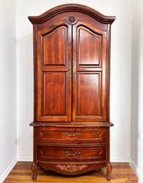 A Large Fruit Wood Wardrobe Cabinet In French Provincial By Bassett Furniture