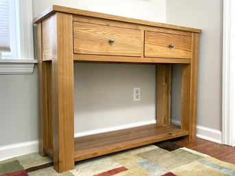 A Petit Oak Console With Drawers And Removable Shelf