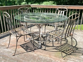 A Pair Of Vintage Salterini Wrought Iron Side Chairs, A Glass Top Dining Table With Ornate Cast Aluminum Base