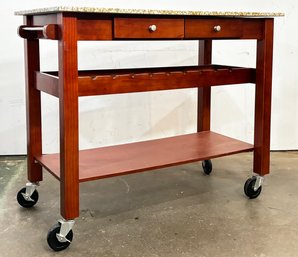 A Cherry Wood And Granite Kitchen Island Or Prep Station