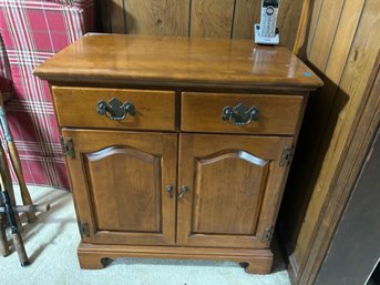 A MAPLE TWO DRAWER OVER TWO DOOR CABINET
