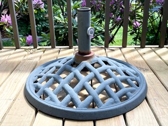 A Cast Iron Umbrella Base With Latticework Detail