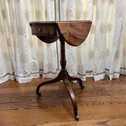 An Antique Tripod Drop Leaf Sewing Table With Drawer