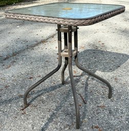 An Outdoor Side Table With Tempered Glass Top