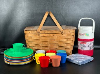 A Vintage Woven Picnic Basket With Supplies