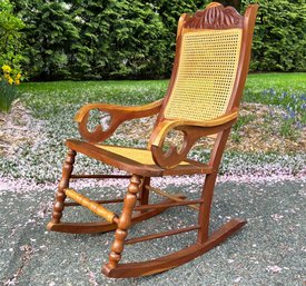 An Antique Mahogany And Cane Rocking Chair