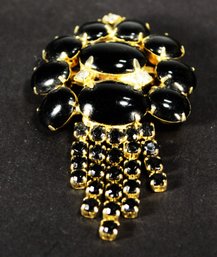 BLACK RHINESTONE 'BADGE' FORMED BROOCH IN GOLD TONE 1960S