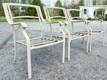 A Trio Of Tubular Metal Outdoor Arm Chairs With Webbed Supports