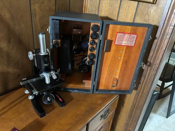 A BAUSCH AND LOMB CASED MICROSCOPE W/ ATTACHMENTS