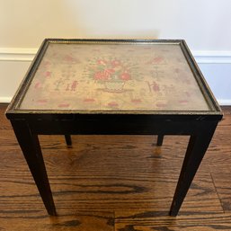 An Antique Sampler Displayed In A Petite Table Under Glass