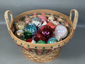A Woven Christmas Basket Full Of Glass Ornaments