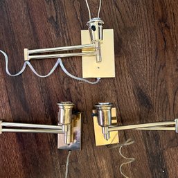 A Set Of 3 Corded Brass Swing Arm Sconces