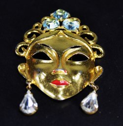 VINTAGE GILT METAL/SILVER? MASK BROOCH HAVING LIGHT BLUE RHINESTONES