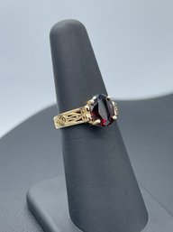 Intricate Design Solitaire Garnet Ring In 14k Yellow Gold