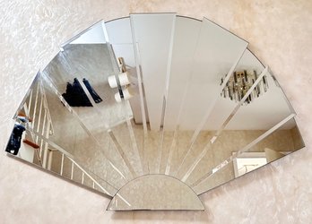 A Large Fan Form Beveled Mirror