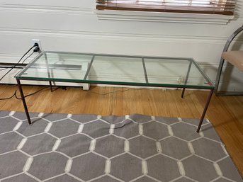 A WROUGHT IRON AND GLASS COFFEE TABLE