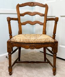 An Antique Carved Wood Arm Chair With Rush Seat