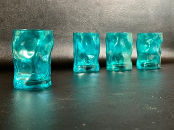 A Set Of Vintage Drinking Glasses With A Wavy Profile In Turquoise