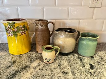 A Collection Of  5 Glazed Pitchers