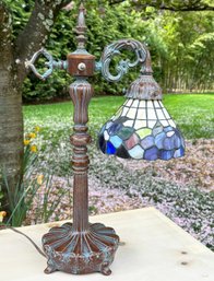 A Bronze And Stained Glass Table Lamp In Tiffany Style