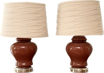 A Pair Of Brick Red Porcelain Table Lamps With Fabric Shades