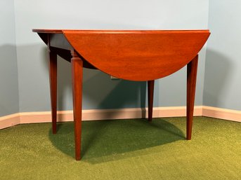 A Vintage Drop Leaf Table In Solid Cherry With Rich Wood Grains