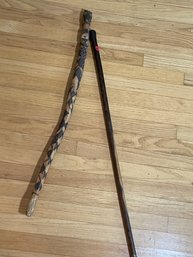 AN ANTIQUE ROSEWOOD WALKING STICK AND A CARVED WALKING STICK