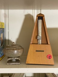 A SETH THOMAS METRONOME AND AN ANTIQUE FOOTED MARBLE JAR