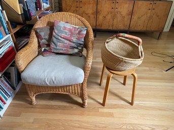 A WICKER ARMCHAIR BASKET AND SIDE TABLE