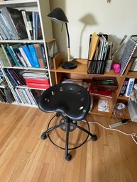 A TRACTOR SEAT STOOL AND CONTEMPORARY TABLE LAMP