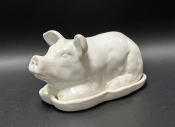 A Covered Butter Dish With A Charming Pig Lid